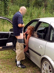 Redhead mom sucks guy dick in the car..